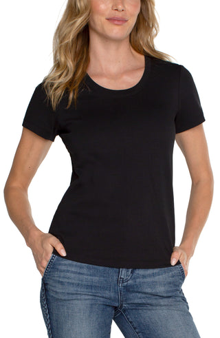 A model wearing a Liverpool scoop neck tee in black with a medium wash denim jean.