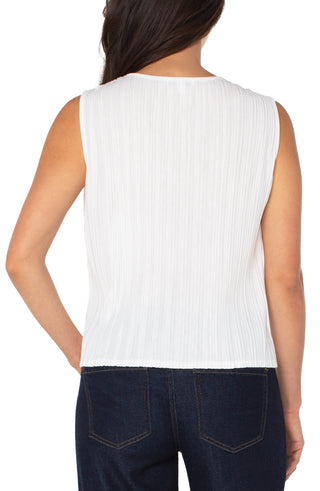 White sleeveless top worn by a person on a white background