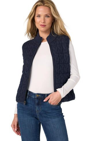 Liverpool Sleeveless Reversible Quilted Sweater Vest in Heather Navy
A woman wearing a navy blue quilted sleeveless vest over a white long-sleeve top and blue jeans, standing against a light gray studio background.
