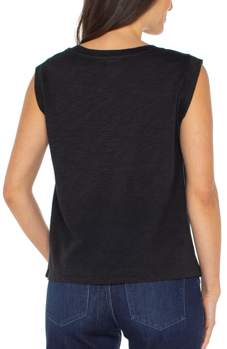 Black sleeveless top worn by a person on a white background