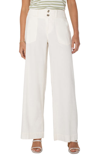 A pair of wide leg, cream-colored utility pants with patch pockets and a button fly closure.