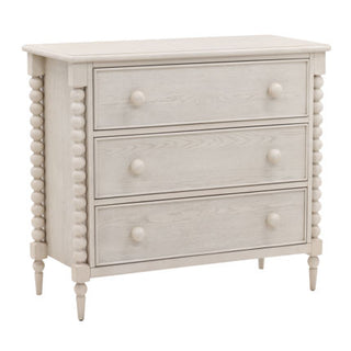 A white Marcellina dresser with spindle legs, featuring a classic design and multiple drawers.