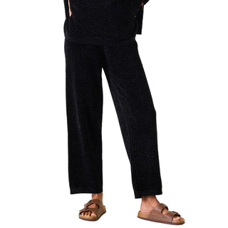 Person wearing black pants and brown sandals on a white background. Mersea Eversoft Chenille Pant in Black