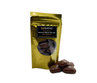Gold packaging of Buoyant Chocolates Banana Bread Pecans with chocolate pecans on a white background