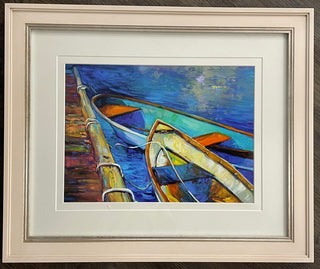 A framed painting titled 'Moored on the Pier' featuring a vibrant image of boats on a pier with a blue and green color palette, enclosed in a wooden frame.