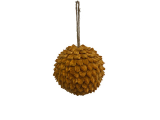 A spherical, textured hanging ornament or decorative piece made of layered mustard-brown scales, suspended by a natural jute rope.