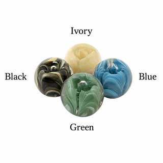 Four marbled knobs in different colors with labels on a white background black ivory cream blue green