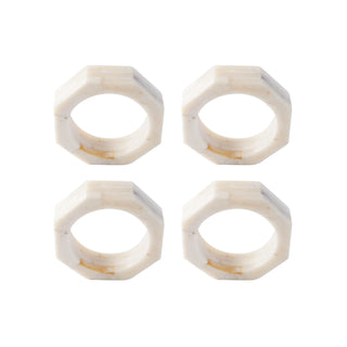 A set of four cream-colored octagon-shaped resin napkin rings.