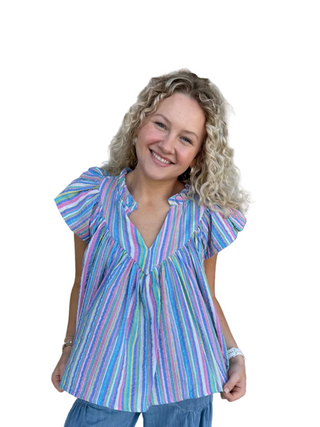 Woman wearing a colorful striped blouse on a white background