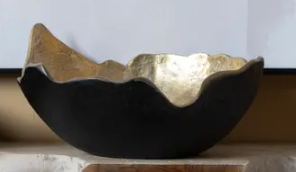 Black and gold decorative bowl on a white background
