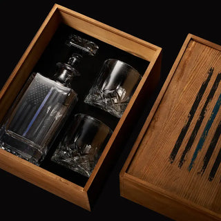 Set of glass decanter and shot glasses in a wooden box with artistic design. Police Tactical Blue Tattered American Flag Whiskey Decanter Set with Two Glasses
