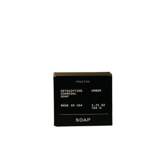 A black bar of Preston Detoxifying Charcoal Soap with the packaging indicating it is made in USA, 3.75 oz.