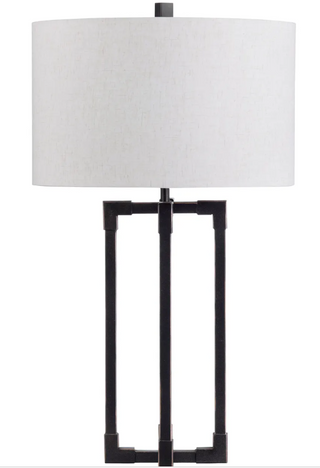 Table lamp with black metal base and white lampshade on a white background