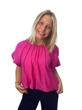 Woman wearing a bright pink shirt