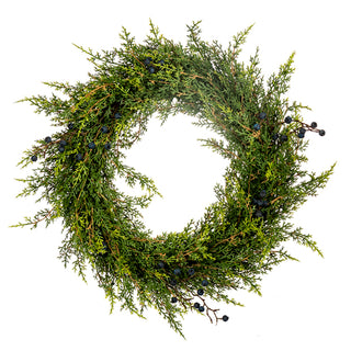 A green evergreen wreath made of dense needle-like foliage with small dark berries, photographed against a plain white background. Real Touch Cedar & Blue Berry Wreath 20"