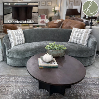 The Redfern coffee table is a durable and stylish table and is crafted with aluminum for a substantial feel and finished in an elegant antique bronze. The scalloped base and large round top provide a touch of sophistication to any space.