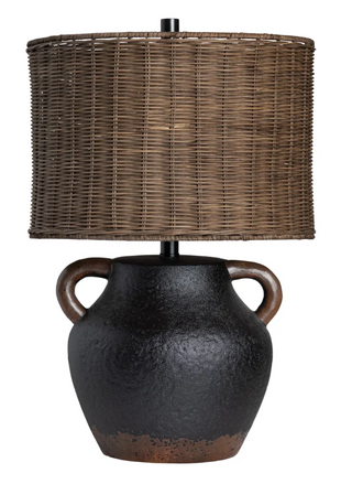 Table lamp with a textured black base and wicker shade on a white background