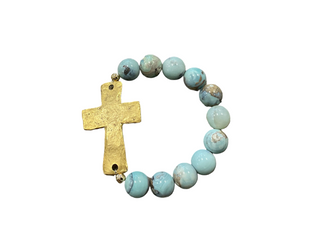 Bracelet with turquoise beads and a gold cross on a white background. Revival Blue Bracelet