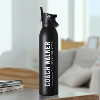 An engraved black stainless steel water bottle with a capacity of 20oz, featuring a slip-free silicone base and a flip-top lid with a black ring.