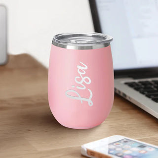 A blush pink colored SWIG wine cup with a removable lid, featuring the brand name 'SWIG' engraved on the front.