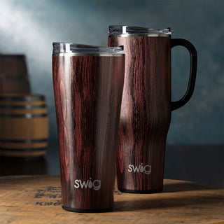 A SWIG branded bourbon barrel mega mug with a capacity of 40oz. The mug is made of stainless steel and has a wooden finish with a black plastic handle and a stainless steel lid.
