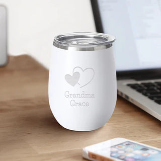 An engraved white stainless steel SWIG wine cup with a removable lid, featuring the brand name 'SWIG' on the front.