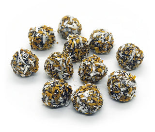 Assorted chocolate truffles with white, gold, and black toppings on a white background salted caramel 