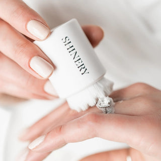 Woman cleaning ring with Shinery Radiance Brush