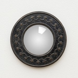 A round convex mirror with a floral garland frame in black color.