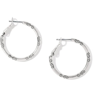 A pair of silver hoop charm earrings with a small heart design. Brighton