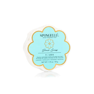 A Spongellé Beach Grass Daisy Spongette, with a floral design packaging predominantly in blue and white colors, with the product visible in the center.