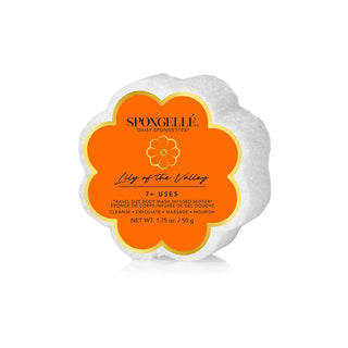 A Spongellé Lily of the Valley Spongette, which is a flower-shaped body wash buffer with a white exterior and orange labeling.
