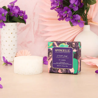 Spongellé Private Reserve Violet Leaf Spongette next to product box with pink background with violet flowers