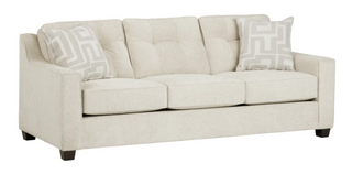 Beige sofa with patterned cushions on a white background