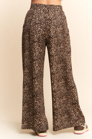 Leopard print pants on a beige background. Taupe Leopard Printed Wide Leg Pants