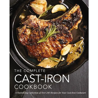 Book cover of 'The Complete Cast-Iron Cookbook' with a cast-iron skillet containing a cooked steak and herbs. The Complete Cast Iron Cookbook