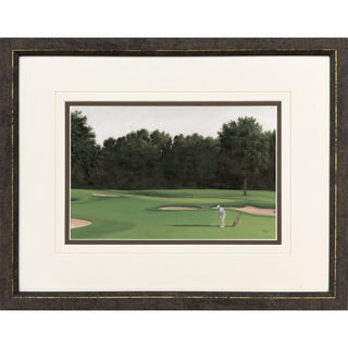 Framed art print of a golf course landscape with a golfer in the fairway green surrounded by a wide white mat and a dark textured wooden frame gold