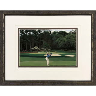 The Fairway Artwork Assorted
A framed matted art print featuring a golfer on a green with trees in the background, presented in a dark wood frame with a white mat gold
