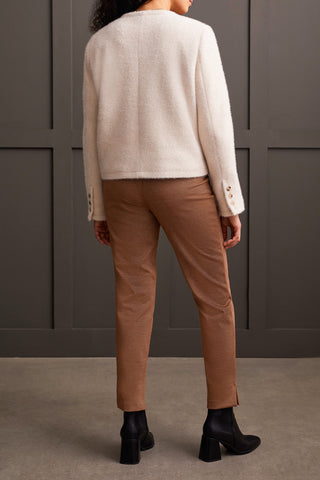 A model wearing a button front, double pocket jacket in moonstone paired with brown pants and black boots.