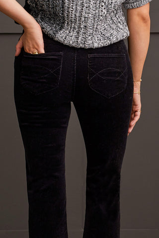 A model wearing black suede pants with flare bottom.