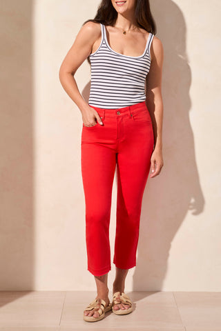 A pair of red Tribal Sophia curvy flared jeans with a released hem, paired with a striped tank top and beige sandals.