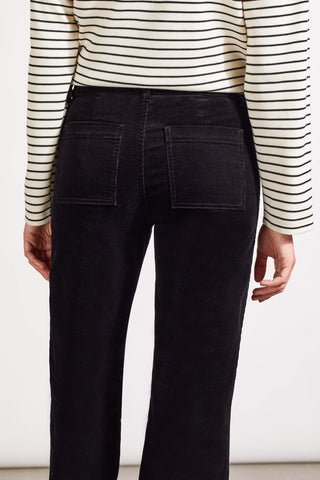 A model wearing Tribal Stretch Corduroy Straight Leg Pants in Black with a striped crop top.