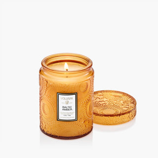 Voluspa Baltic Amber Small 5.5oz Jar candle in a textured glass jar with a white background