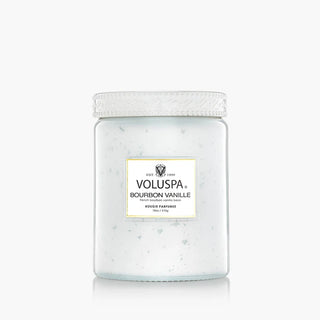 A jar of Voluspa Bourbon Vanille body butter with white speckled wax inside, featuring a white textured lid and a white label with gold borders, set against a clean white background. Voluspa Bourbon Vanille Large 18oz Speckle Jar Candle