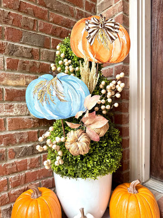 Whimsical Wheat Pumpkin Metal Stake Assorted
two large painted pumpkins in orange and light blue, green boxwood foliage, beige wheat stem metal easel