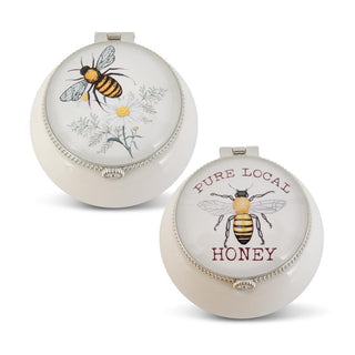 Two round containers with bee designs and 'Pure Local Honey' text on a white background. White Porcelain Trinket Box with Bee Assorted