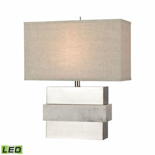 A modern table lamp with a white shade and silver base, featuring a keystone design. White & Silver Keystone Table Lamp