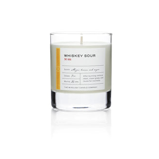 A cocktail-inspired candle with a white label that reads 'Wixology Candle Co., Whiskey Sour'.
