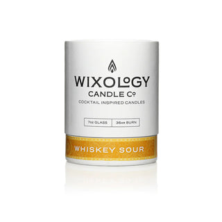 A cocktail-inspired candle with a white label that reads 'Wixology Candle Co., Whiskey Sour'.