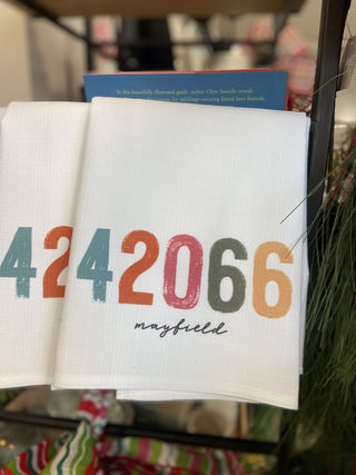 Zip Code tea towel with multicolored numbers and city name written in black script
